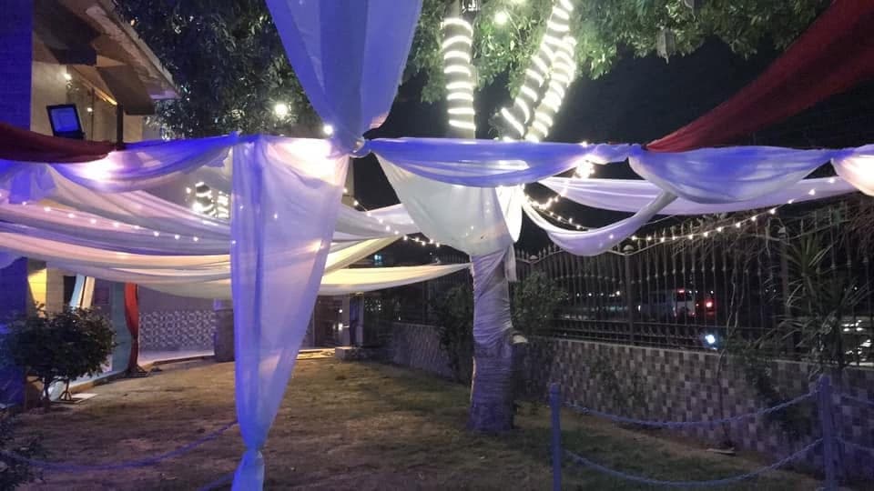 White draped marquee ceiling above banquet tables laid for guests at Ahmed Palace