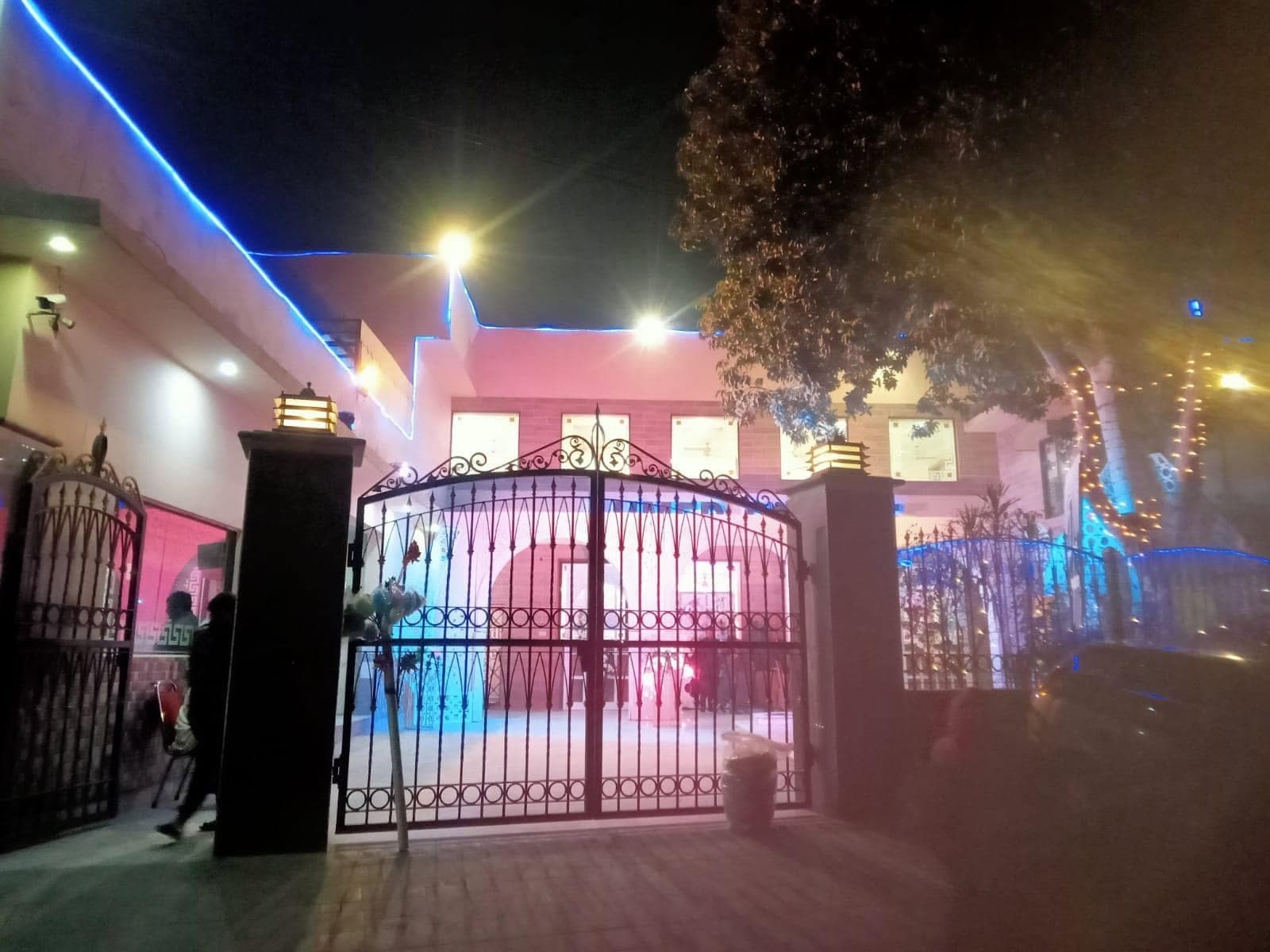 Front gate of Ahmed Palace on Main Canal Road, lit for an evening function