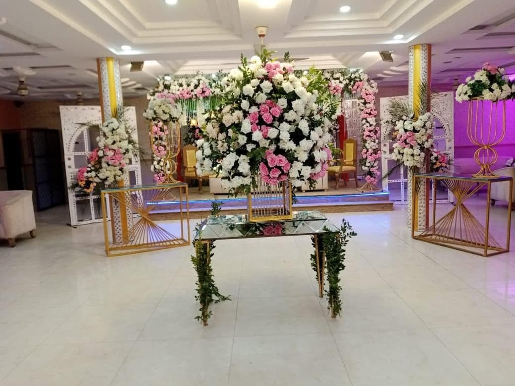 Banquet hall interior with a floral centrepiece table and mirrored panelling