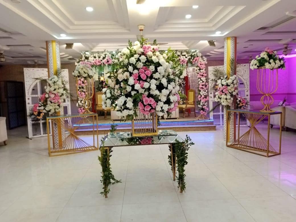 Hall interior at Ahmed Palace showing mirrored wall panels and a flower-dressed console table