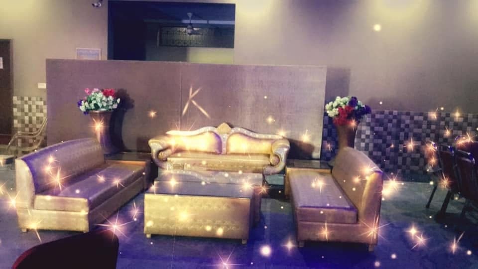 Gilded stage sofa picked out by warm string lighting at Ahmed Palace