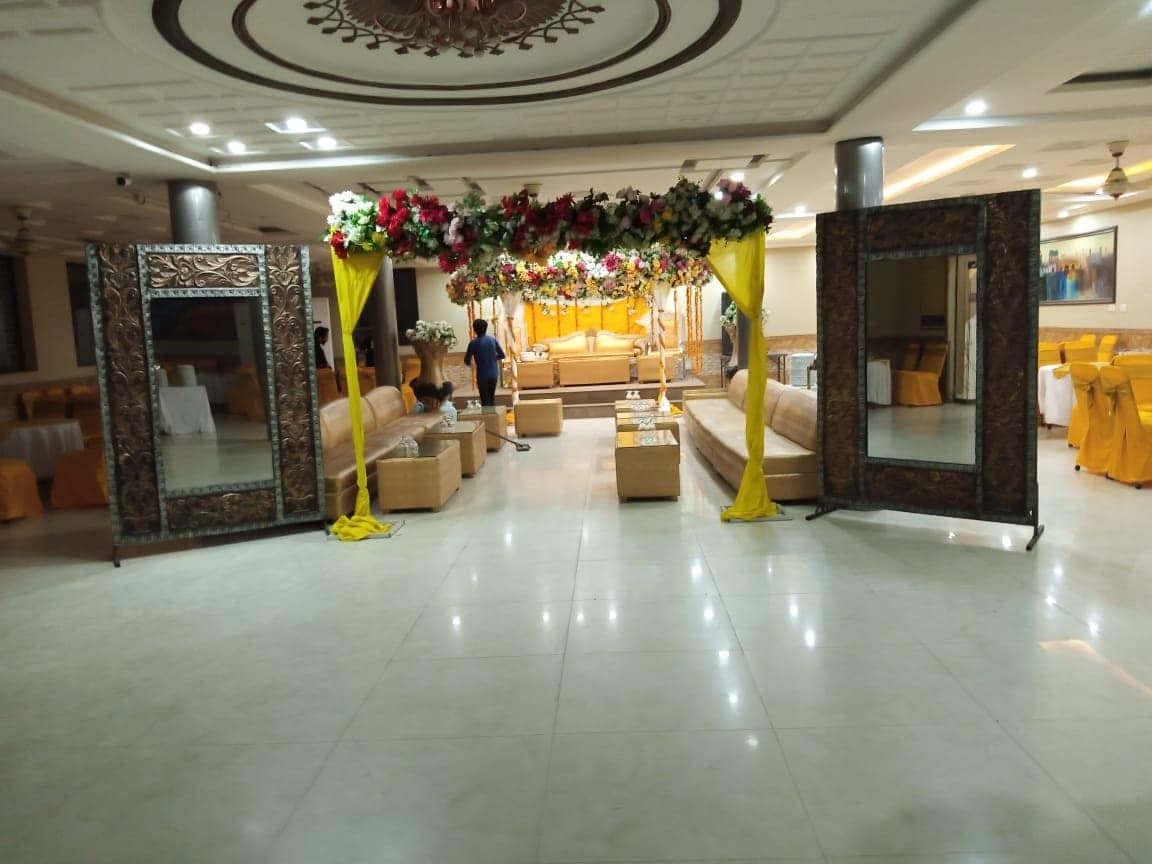 Main banquet hall at Ahmed Palace with a marble aisle leading to a floral entrance arch